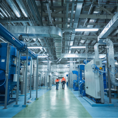 Industrial facility with workers and equipment, depicting manufacturer success through B2B ecommerce digital agency solutions