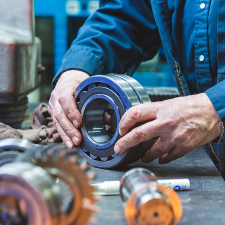 Bearing Service technician inspecting an industrial bearing, reflecting successful ecommerce development agency services