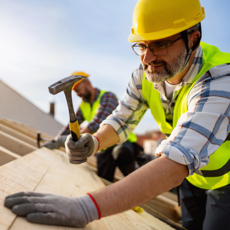 Construction worker on roof structure, representing success with digital marketing for Champion Roofing professional services