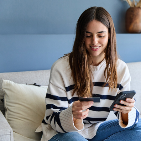 Credit union member using smartphone and credit card for secure digital payments and online banking services