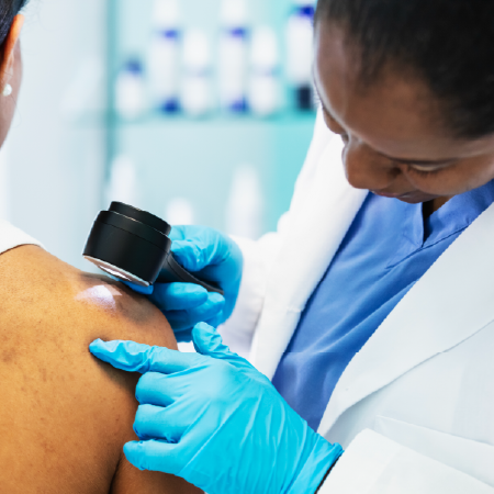 Dermatologist using skin imaging device, indicating success with digital agency services for skin care product manufacturer
