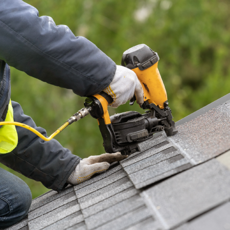 Roofer repairing roof, reflecting Fargo Roofing & Siding's successful digital marketing strategy with digital agency services