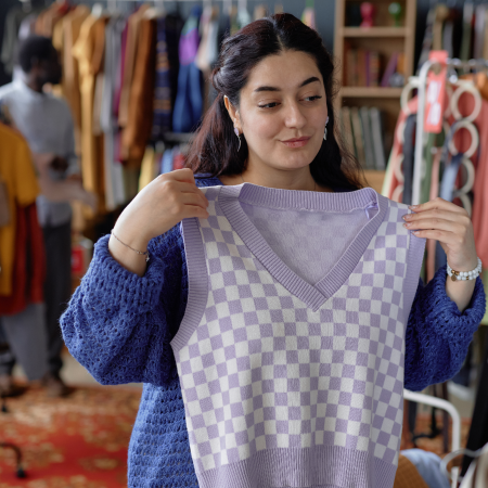 Person thrift shopping in a Goodwill store, signifying success with digital agency services for nonprofit organizations