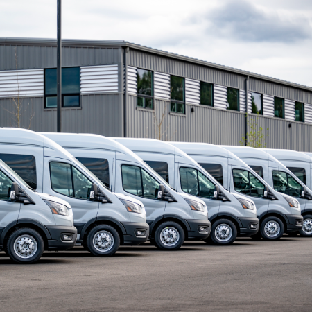 Transportation fleet of commercial vans, showcasing website design, ecommerce development, and integration success