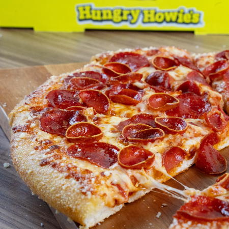 Hungry Howie's pizza box and sliced pizza, signifying success with SEO agency services for pizza delivery and carryout