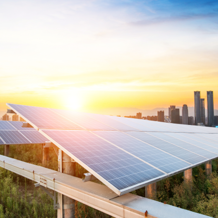 Urban solar panels on city building rooftop, representing success with Liferay development services for energy provider