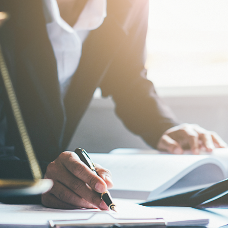 Professional signing legal documents, indicating business success with web design and development services for law firm
