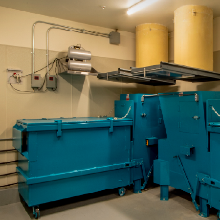 Industrial waste chute system in a facility room, highlighting business success with digital agency services for manufacturer