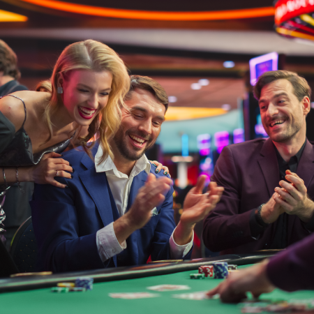 People at a casino table celebrating during a game showing success with digital marketing services for entertainment industry