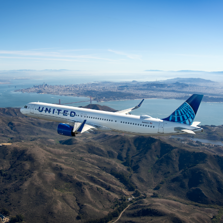 Scenic aerial view of United Airlines plane flying in the sky, showcasing brand success with digital agency services