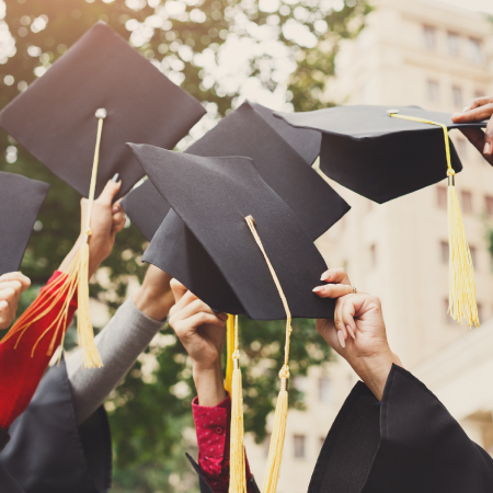graduates celebrating by tossing caps in air, indicating success with digital marketing and web development agency services