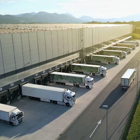 Trucks at a distribution center, showcasing Beltmann Logistics’ success with digital agency solutions for logistics services