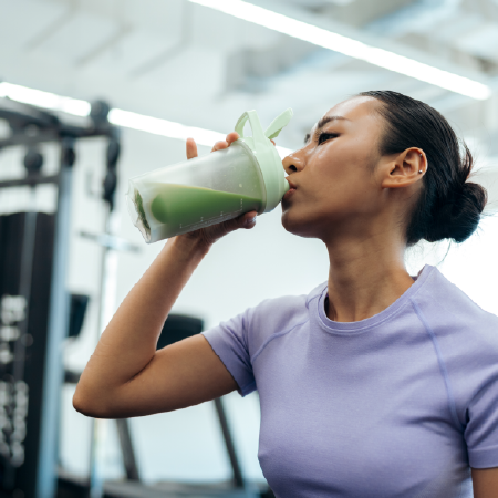 Athlete drinking energy drink at the gym, depicting successful digital solutions for health and wellness product manufacturer