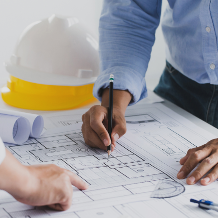 Architects collaborating on building plans, indicating business success with digital marketing and web development services