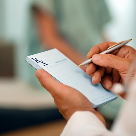 Doctor writing a prescription on a notepad showing business success with digital marketing agency services for ecommerce