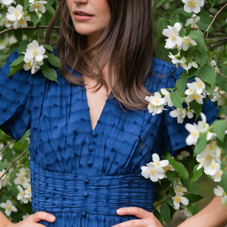 Woman wearing an elegant spring dress, showcasing business success with digital agency services for luxury fashion brand